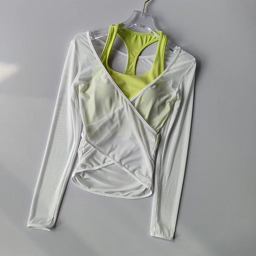 Light gray long-sleeve wrap top with green sports bra on a gray background