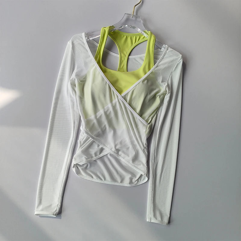 Light green sports bra and long-sleeve wrap  top on a hanger against a gray background