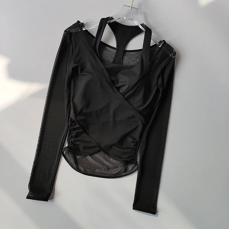 Black long-sleeve wrap top with sheer overlay on a white background