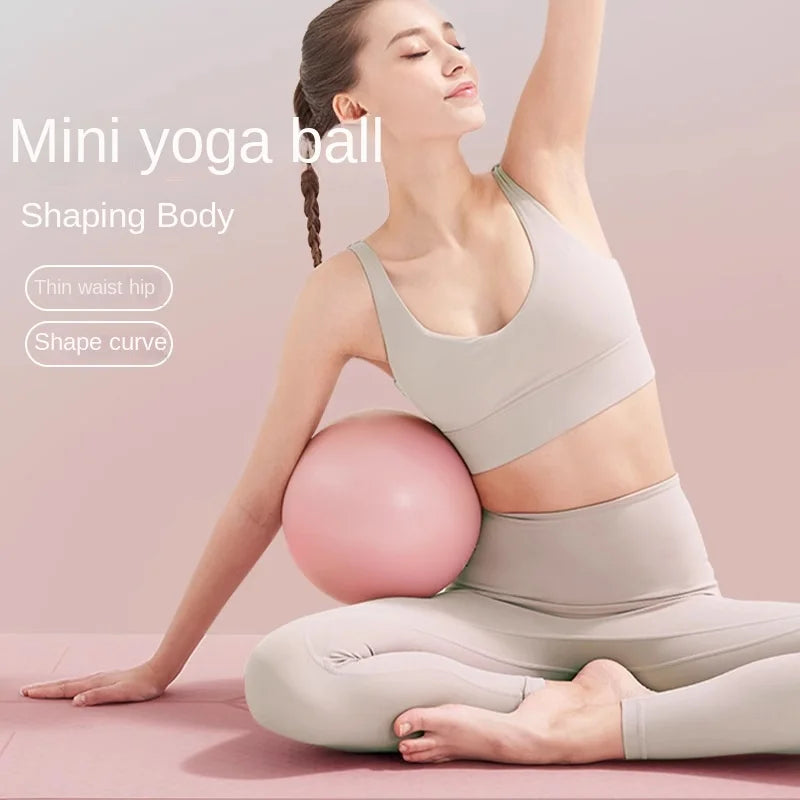Woman using a pink yoga ball for body shaping on a pink background
