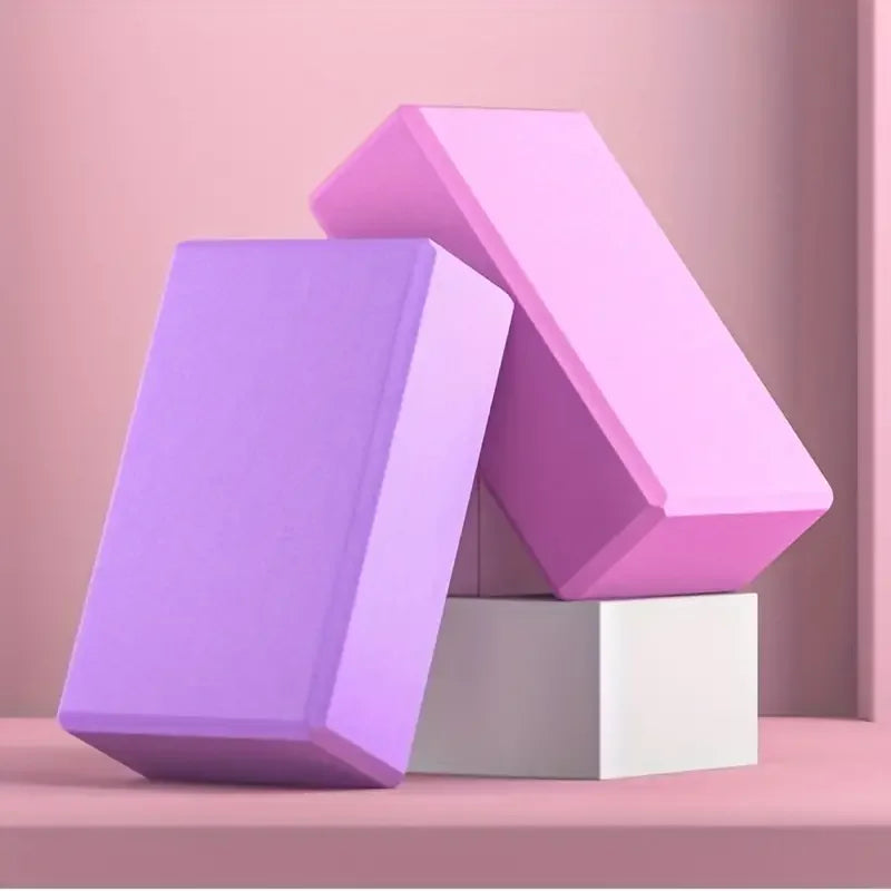 Three-dimensional geometric shapes in purple and pink on a pink background