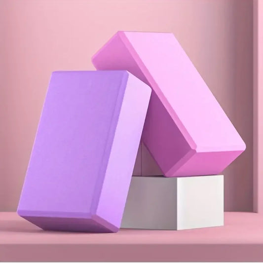 Three-dimensional geometric shapes in purple and pink on a pink background