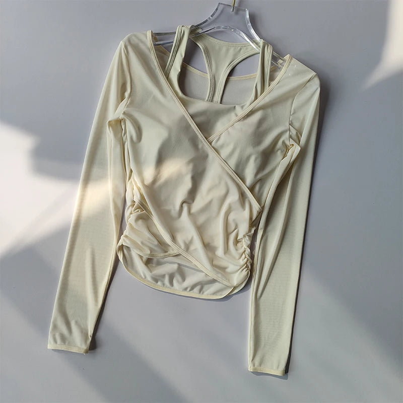 Beige long-sleeve wrap top on a hanger against a gray background